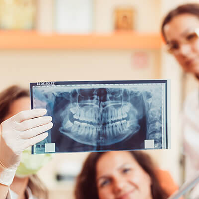 Dentist reviewing a patient's root canal x-rays