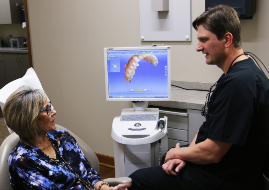 Dr. Volker speaks with a patient in his practice in Wichita, KS